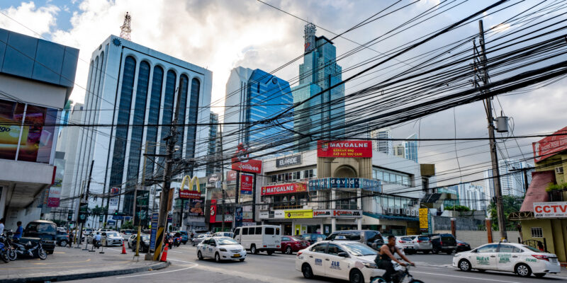 Power transmission lines above a busy road in Manila, Philippines. Renewable electricity is cheaper to produce in the Philippines than electricity from gas, meaning relying on gas could result in higher bills.