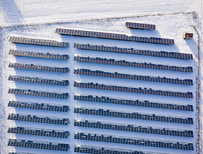 Aerial view of a solar farm in Poland in winter, surrounded by snow. Even in winter, solar PV contributes to Poland's energy mix.